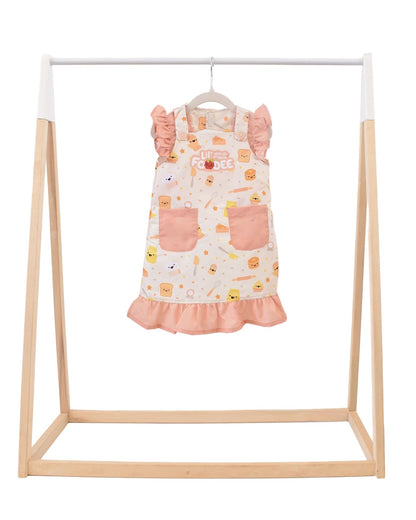 Lil' Foodee Lil Baker frill apron featuring pastel baking icons and ruffled edges.
