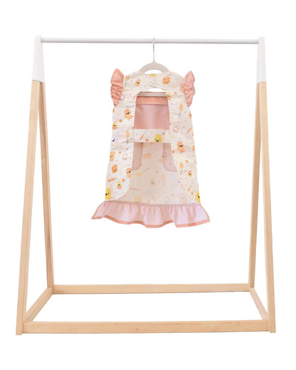 Lil' Foodee Lil Baker frill apron featuring pastel baking icons and ruffled edges.