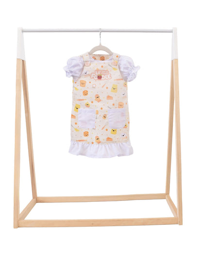 Lil' Foodee Lil Baker puff-sleeve apron in pastel baking print with cupcakes, whisks and sprinkles.
