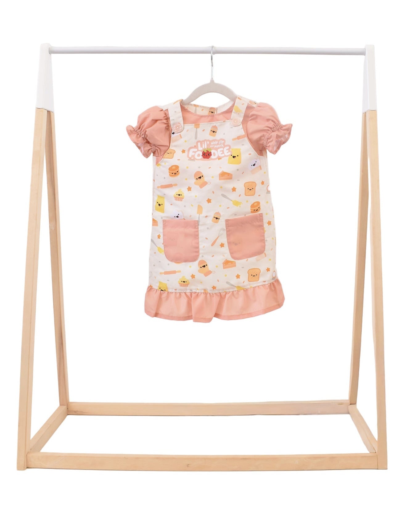 Lil' Foodee Lil Baker puff-sleeve apron in pastel baking print with cupcakes, whisks and sprinkles.